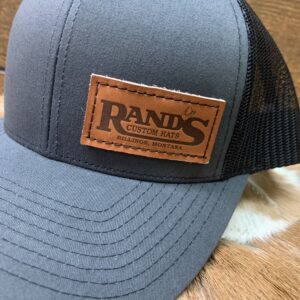 Rand’s Custom Hand Stitched Mid profile snapback mesh trucker hat with a leather stitched patch