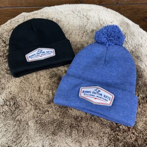 Black Beanie no Pom and Heather Royal Blue with Pom Pom. Cuffed Beanies with Rand’s Custom Hat Embroidered Patches